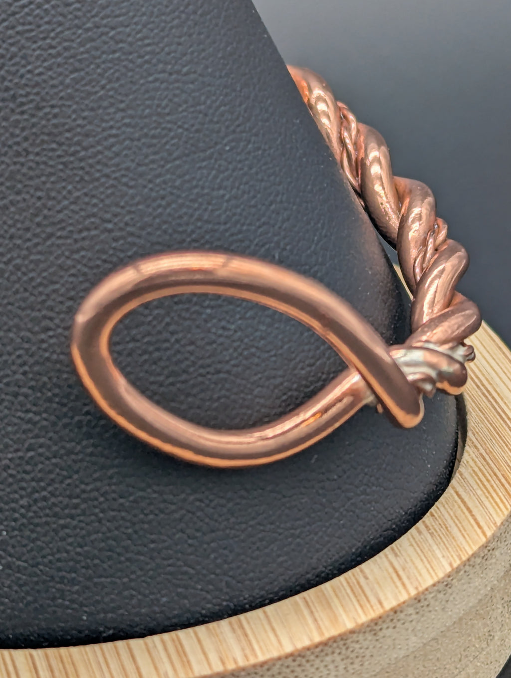 Zoomed in photo showing one of the ends of a twisted wire copper cuff.