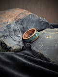 Heavy copper ring with turquoise inlay design on a textured surface